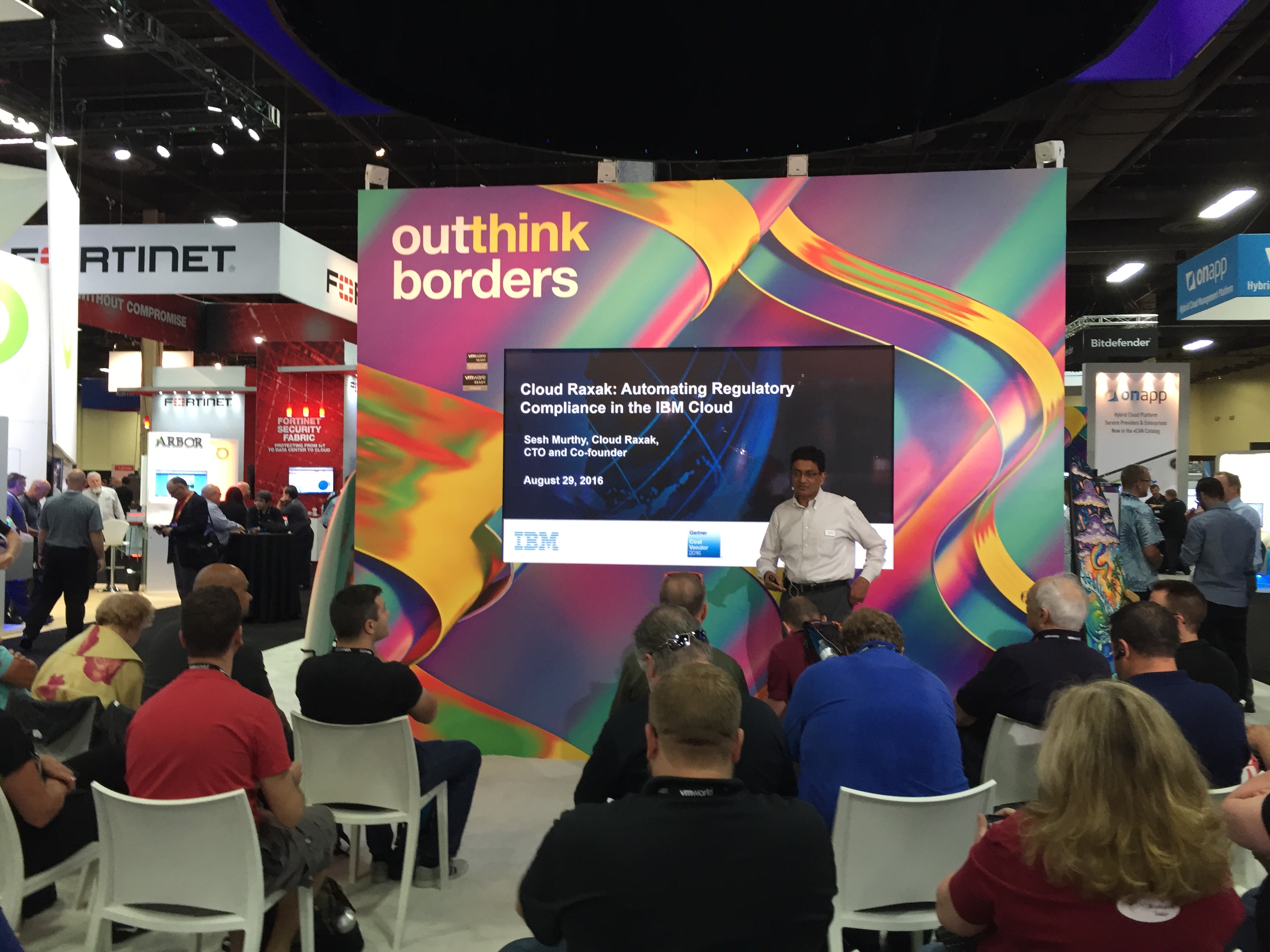 Cloud Raxak's CTO Sesh Murthy at VMworld giving a theater presentation on automating regulatory compliance in the IBM Cloud.